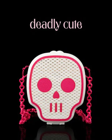 White 3D printed skull purse with hot pink facial features and a bright pink chain, blending spooky with sweet.