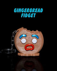 Gingerbread fidget keychain with shocked face and bite mark