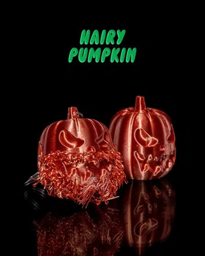 Two Halloween pumpkins — one hairy, one smooth — with spooky faces