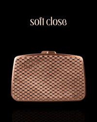 Bronze-toned 3D printed purse with a rectangular shape, soft-close top, and a simple mesh design for minimalist elegance.