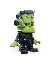 Three-quarter view of a spooky green monster figurine showing the face and side profile.