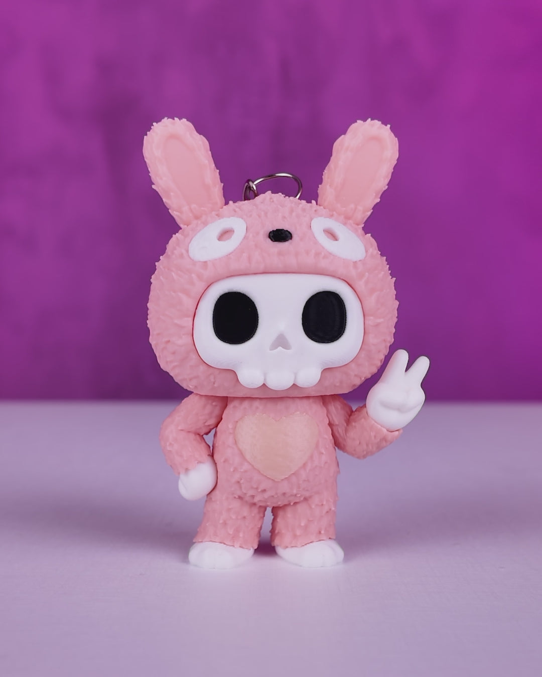 Pink Bunny Suit Skull Figurine